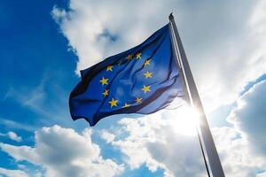 The flag of the European Union against the blue sky. photo