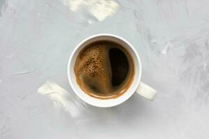 Cup of black coffee on light gray background photo