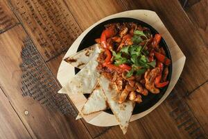 Fajitas with chicken and bell pepper in a pan photo