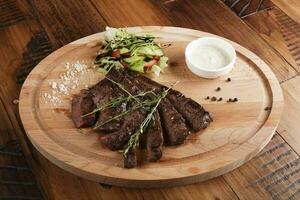 Skirt steak with salad and sauce. photo