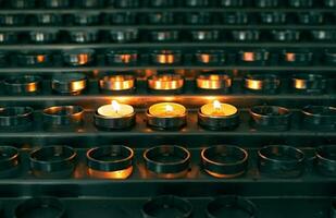 Closeup shot of burning candles in the church photo