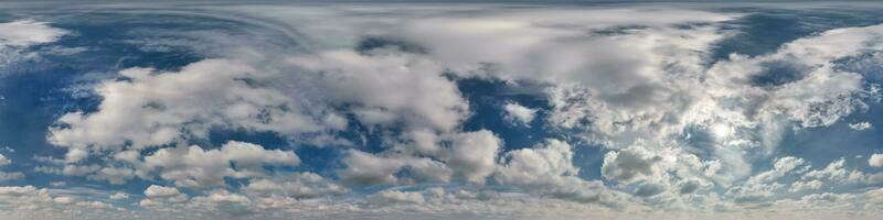 hdri 360 panorama of blue sky with sun and cumulus clouds with zenith in spherical equirectangular projection may use for sky dome replacement in 3d graphics or game development and edit drone shot photo