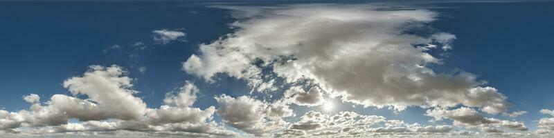 hdri 360 panorama of blue sky with sun and cumulus clouds with zenith in spherical equirectangular projection may use for sky dome replacement in 3d graphics or game development and edit drone shot photo