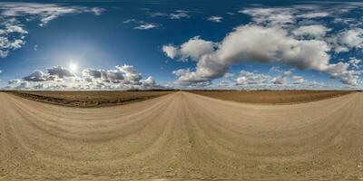 spherical 360 hdri panorama on gravel road with clouds on blue sky in equirectangular seamless projection, use as sky replacement in drone panoramas, game development as sky dome or VR content photo