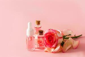 A set of cosmetics based on rose oil for face and body skin care. natural cosmetics. Pink background. A copy of the space. photo