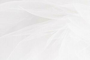 Delicate texture of the background. Elegant soft tulle fabric. Bridal wedding foil close-up for design, plase for text. photo