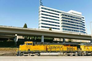 Tacoma, Washington, USA. March 2021.The locomotive of a freight train in the city center rides on the railway photo