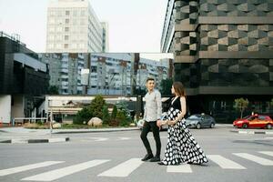 a young family is waiting for the baby. Husband and wife look at each other as they walk through downtown. photo