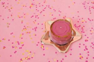 Trendy pink bento cake for Mom's day, birthday, Valentine's Day on a golden plate in the shape of a star on a pink background with confetti photo