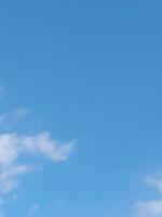 Beautiful white clouds on deep blue sky background. Large bright soft fluffy clouds are cover the entire blue sky. photo