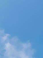 Beautiful white clouds on deep blue sky background. Large bright soft fluffy clouds are cover the entire blue sky. photo