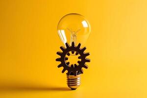 Light bulb with gears ideas concept yellow background. photo