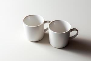 A top down look at two coffee mugs on a white background. photo