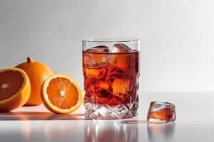 Negroni cocktail in crystal glass with ice cubes and orange slice on white background. photo