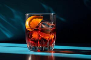 Popular cocktail negroni with gin and vermouth on blue background with shadow negroni cocktail. photo