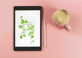 flat lay of digital tablet with picture of house plant in watercolor style on screen,  pink stylus pen,   isolated on  pink background. Digital art concept. photo