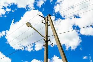 Power electric pole with line wire on colored background close up photo