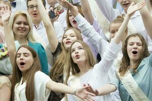 Belarus, the city of Gomel, May 30, 2019. Graduation at school. School graduates waving their hands. photo