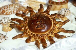 Yeast roll in the form of a Slavic sun. photo