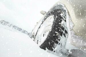 Car wheel in a snowy white snowdrift. photo
