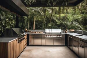 An outdoor kitchen with a sleek gas grill and stainless steel appliances set against the backdrop of a lush est. photo