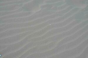 White sand texture background with wave pattern photo