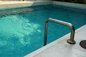 Swimming pool with stainless handrails at resort photo