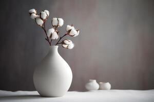 A Serene Still Life of Cotton Branches in a White Vase. photo