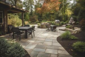 A patio with chairs tables and a fire place in the middle of the yard with a grill and grill in the back ground. photo