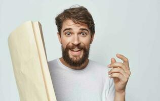 cheerful man in a white t-shirt with a package in his hands photo