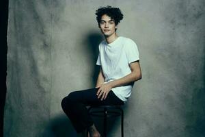 glamorous teenager in pants and t-shirt curly hair fabric backdrop photocall studio photo