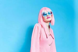 woman in pink wig and dress on blue background photo