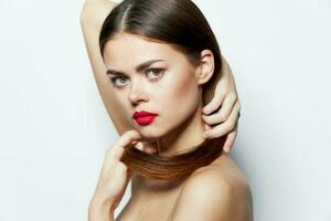 Brunette Naked shoulders red lips clean skin holds hair with hands natural look photo