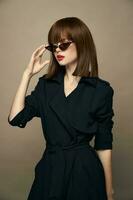 Brunette Fashionable glasses on the face red lips photo