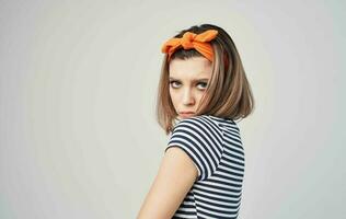 woman in striped t-shirt with bandage on her head posing close-up photo