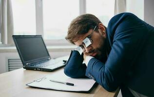 man in the office in front of a laptop in the office work photo