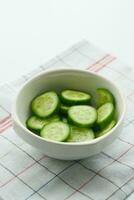 close up of slice of cucumber in a bowl on table photo