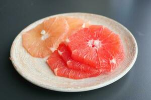 Fresh grapefruits on a plate photo