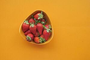 Ripe Red Strawberries in a bowl on table photo