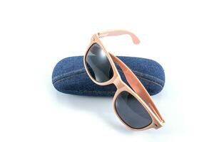 pink sunglasses in jean case photo