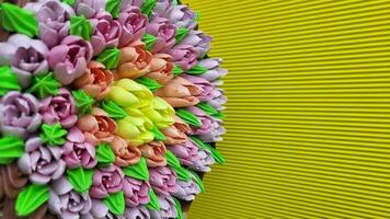 Multicolored cream tulips on a cake on a background of yellow corrugated paper photo