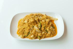 Stir fried crab meat with curry delicious seafood in a white plate. photo