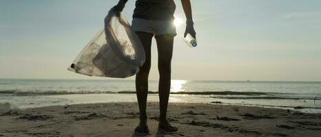 Save water. Volunteer pick up trash garbage at the beach and plastic bottles are difficult decompose prevent harm aquatic life. Earth, Environment, Greening planet, reduce global warming, Save world photo