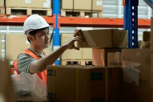 Warehouse worker pick box goods in inventory and check stock product. Transport logistic business ship delivery to customer. stock card, bill of material, inspection, storehouse, storage, factory photo