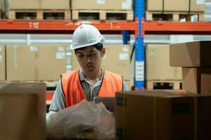 Asian male factory inspect goods in warehouse or inventory and check stock product. Transport logistic business shipping, delivery to customers. inspection, storehouse, storage, factory photo