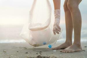 Save water. Volunteer pick up trash garbage at the beach and plastic bottles are difficult decompose prevent harm aquatic life. Earth, Environment, Greening planet, reduce global warming, Save world photo