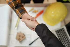 Construction worker team hands shaking greeting start up plan new project contract in office center at construction site, industry ,architecture, partner, teamwork, agreement, property, contacts. photo