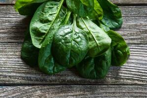Spinach leaves on wooden table, closeup photo