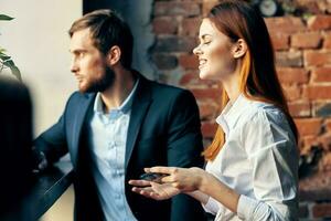 man and woman sitting in cafe communication officials lifestyle photo