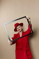 fashionable woman with wooden frame posing red suit Lifestyle posing photo